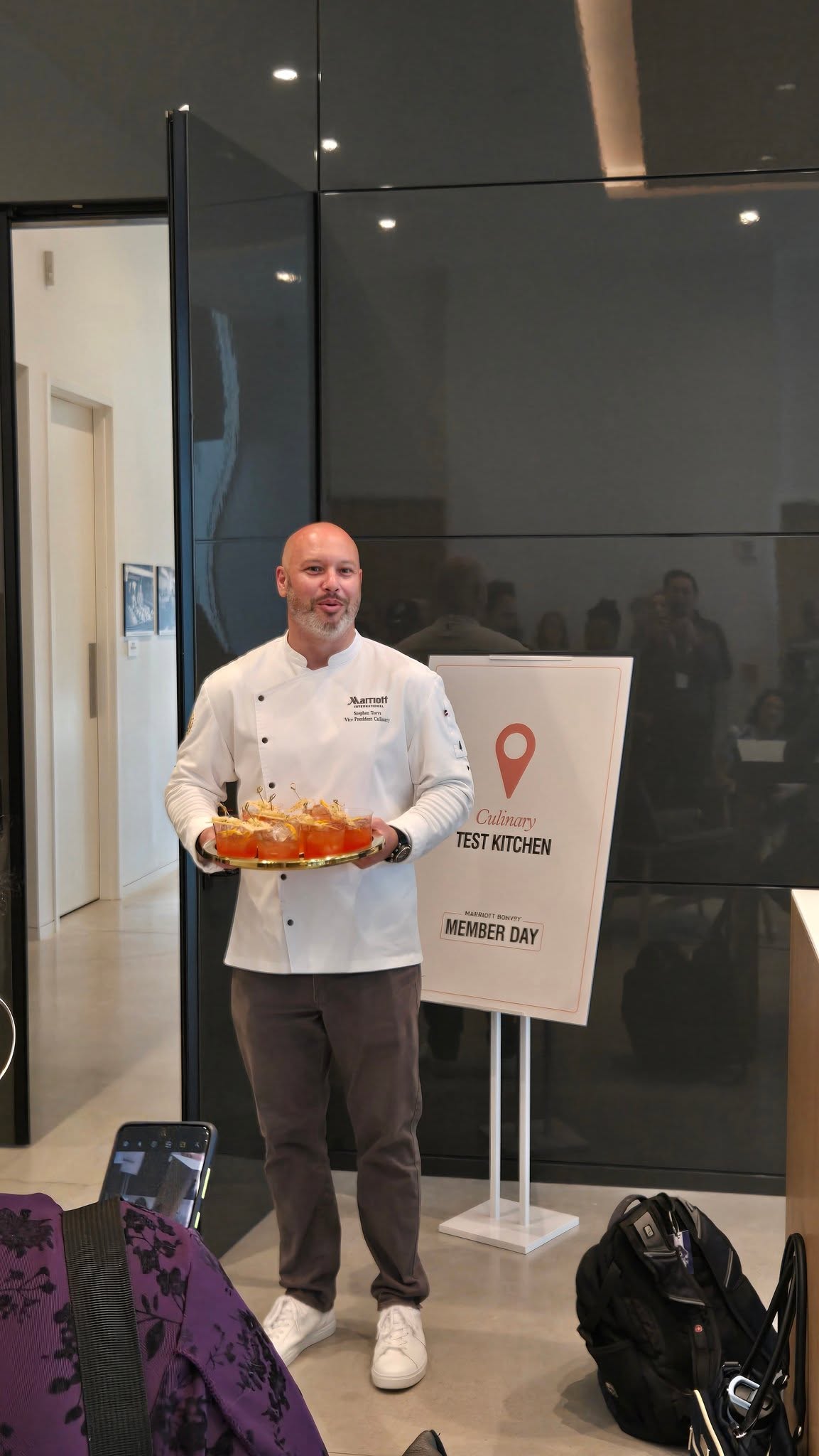 Marriott Executive VP Culinary Greeting Attendees with Welcome Cocktails at the Test Kitchen