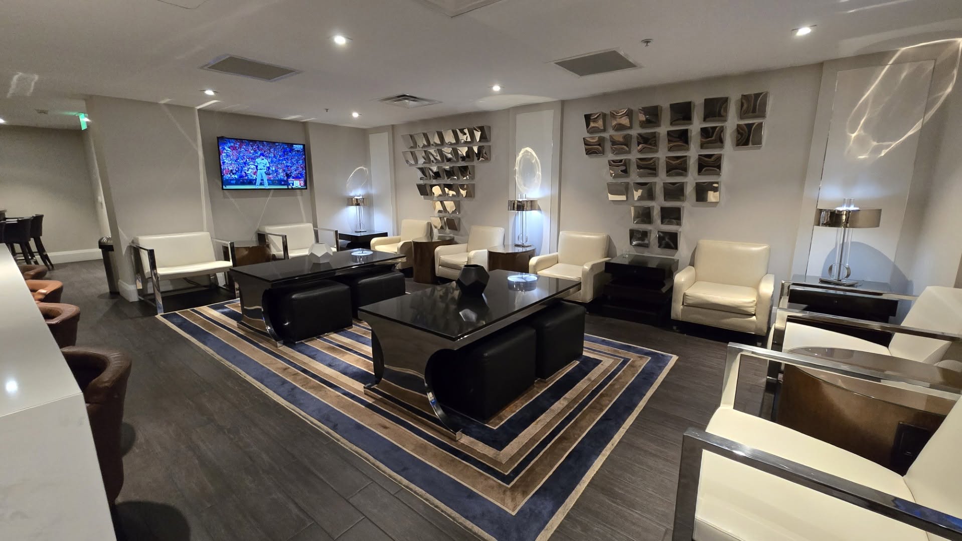 M Club executive lounge seating area with chrome wall art