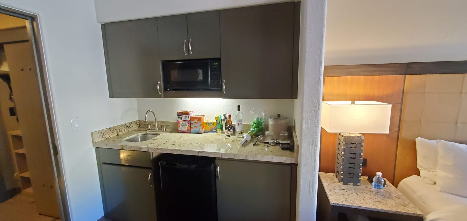 Casita wet bar staged with cocktail glassware, shaker, ice bucket, and bar supplies. Kitchenette bar station fully stocked with cocktail essentials