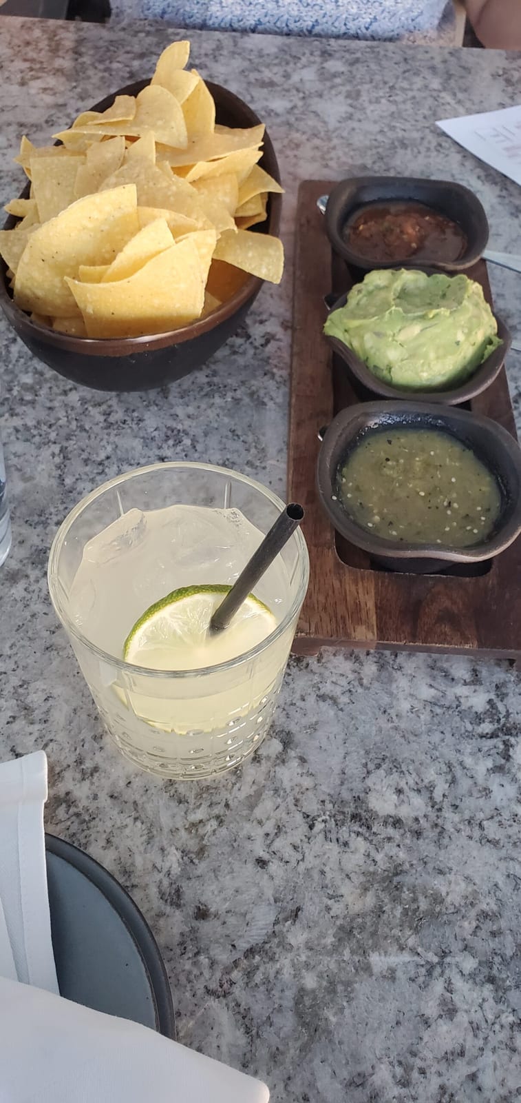 Hand-shaken margarita on the rocks paired with warm tortilla chips, guacamole, and house salsa trio. Rita's signature margarita on the rocks with tortilla chips and salsa trio