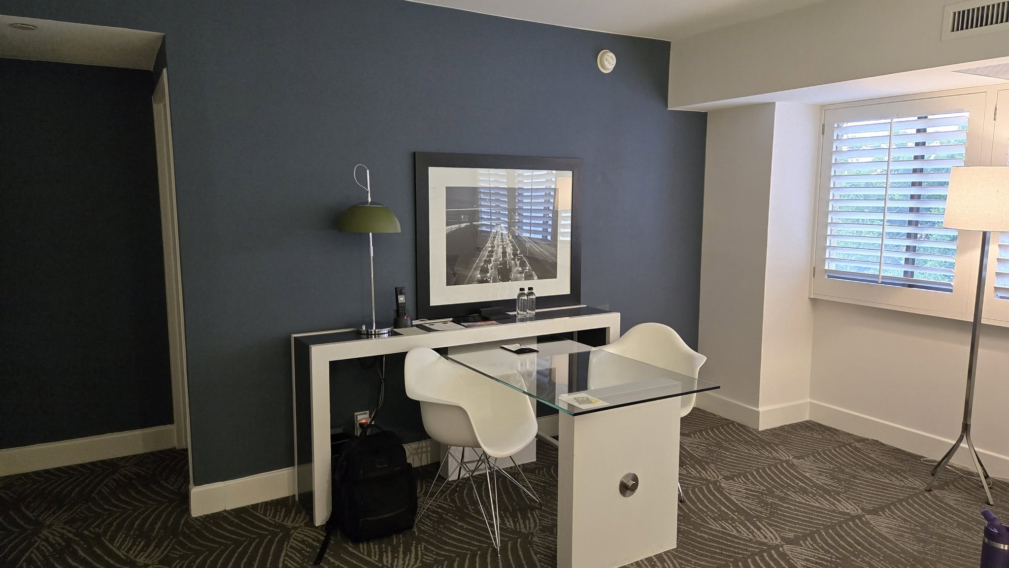 Dedicated glass executive workstation desk and modern task chairs in Suite 522