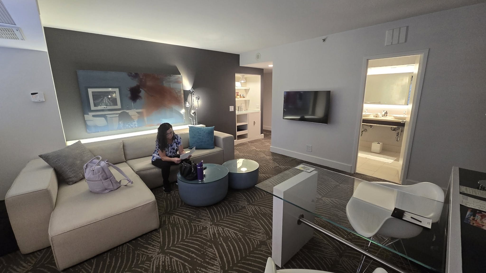 Maureen Salvatore working from the sectional sofa in Fabulous Suite 522