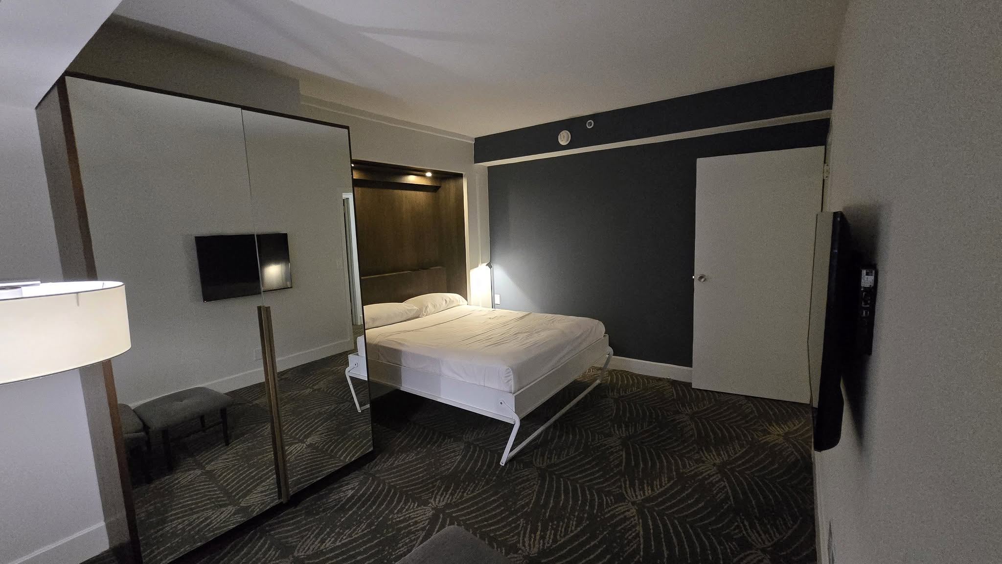 Suite 522 living room with custom Murphy fold-down secondary bed deployed